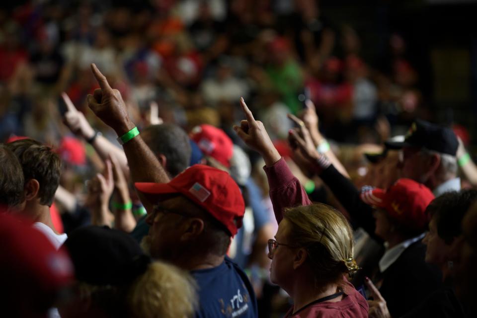 Donald Trump supporters hold up the index fingers while the former president spoke at a rally in Youngstown, Ohio, on Sept. 17.