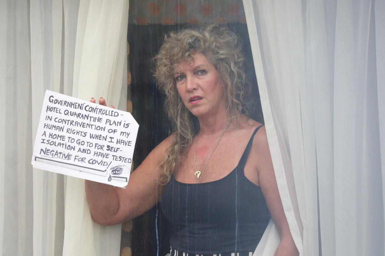 A quarantined traveller holds a sign up to the window of her room at the Radisson Blu Edwardian hotel, near Heathrow Airport, London, a Government-designated quarantine hotel being used for travellers to stay during a 10-day quarantine after returning to England from one of 33 