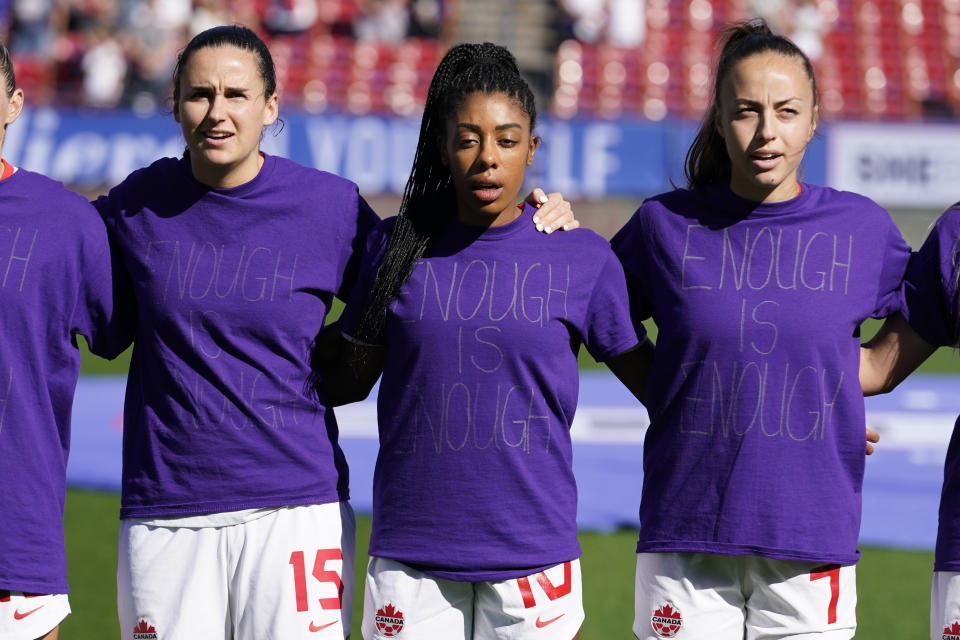 Canada's Evelyne Viens, left, Ashley Lawrence, center and Julia Grosso ( 7) wear their shirts inside out during the national anthem before a SheBelieves Cup soccer match against Japan Wednesday, Feb. 22, 2023, in Frisco, Texas. (AP Photo/LM Otero)