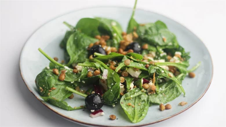 Lentil and spinach salad on blue plate