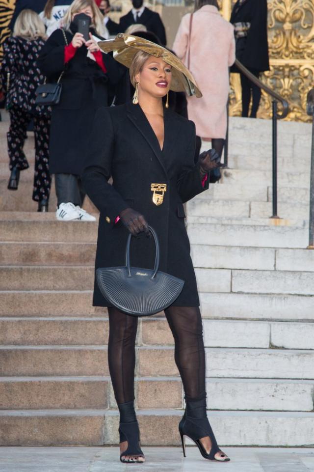 Laverne Cox flashes the flesh in a cut-out bodysuit beneath a sheer dress  at Gaultier's PFW show