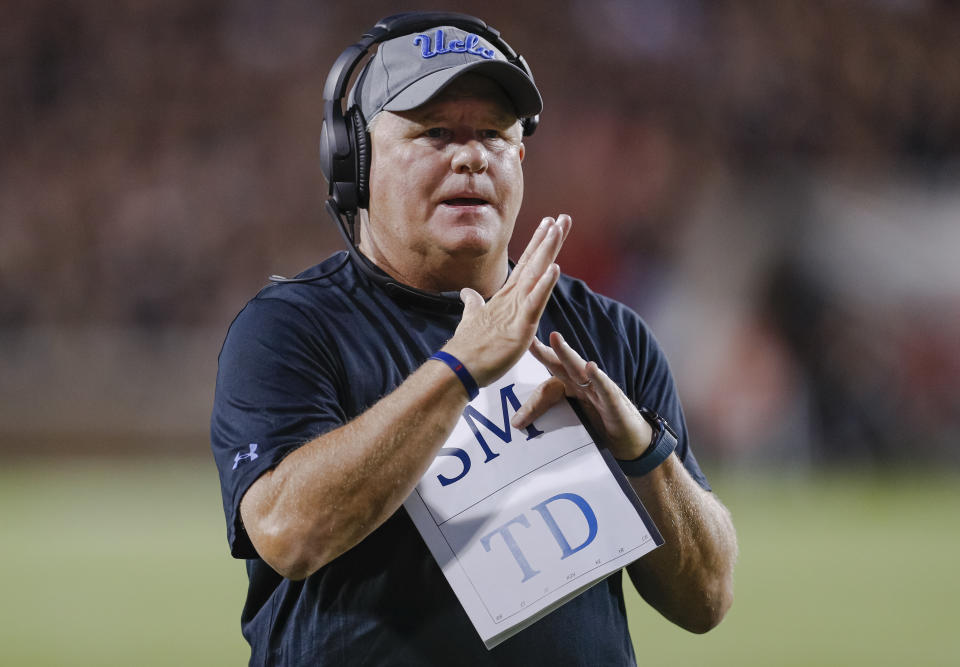 Head coach Chip Kelly of the UCLA Bruins signals for a timeout during the game against the Cincinnati Bearcats. (Getty)