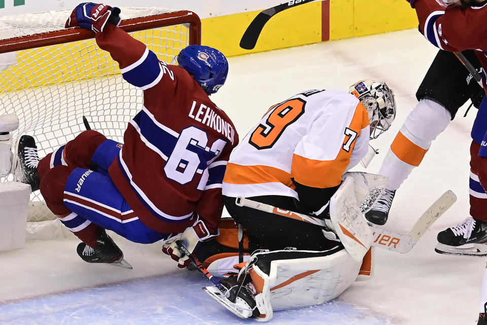 Philadelphia Flyers goaltender Carter Hart (79) makes a save as Montreal Canadiens left wing Artturi Lehkonen (62) runs into the net during the second period of Game 3 of an NHL hockey playoff first-round series Sunday, Aug. 16, 2020, in Toronto. (Frank Gunn/The Canadian Press via AP)