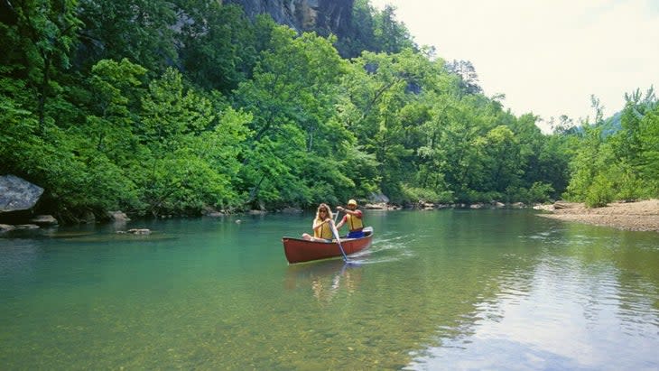 Two paddlers ply a canoe down Arkansas's Buffalo National River