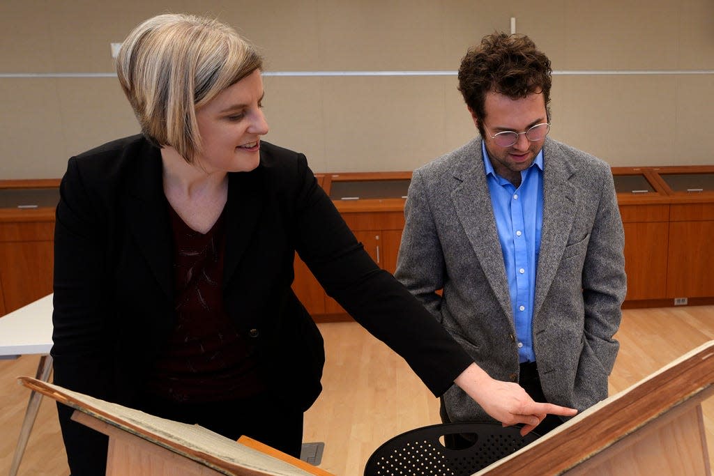 Max Chapnick, a postdoctoral teaching associate at Northeastern University, right, looks as Elizabeth Pope, curator of Books & Digital Collections, points out a writing by "E. H. Gould" at the American Antiquarian Society, a national research library of pre-20th century American history and culture, on Jan. 9 in Worcester. Chapnick believes he has found about 20 stories and poems at the library written by Louisa May Alcott under her own name as well as pseudonyms, including E. H. Gould, for local newspapers in Massachusetts in the late 1850s and early 1860s.