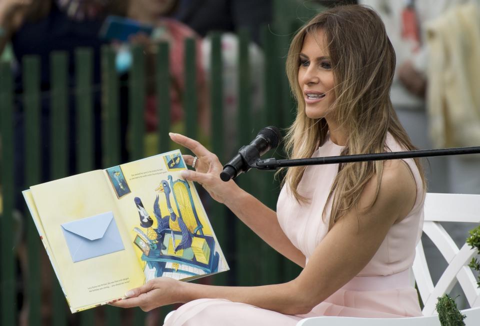 First lady Melania Trump reads a book during the 139th White House Easter Egg Roll.