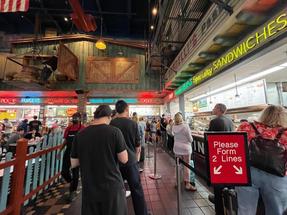 Two lines of people waiting to order at Portillo's.