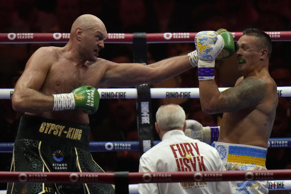 Britain's Tyson Fury, left, punches Ukraine's Oleksandr Usyk during their undisputed heavyweight world championship boxing fight at the Kingdom Arena in Riyadh, Saudi Arabia, Sunday, May 19, 2024. (AP Photo/Francisco Seco)