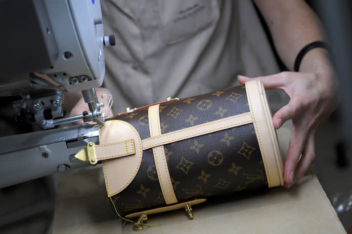 A craftwoman works on a chest on October 12, 2018 at the Louis Vuitton leather work factory in Juilley, western France.  | LOIC VENANCE/Getty Images