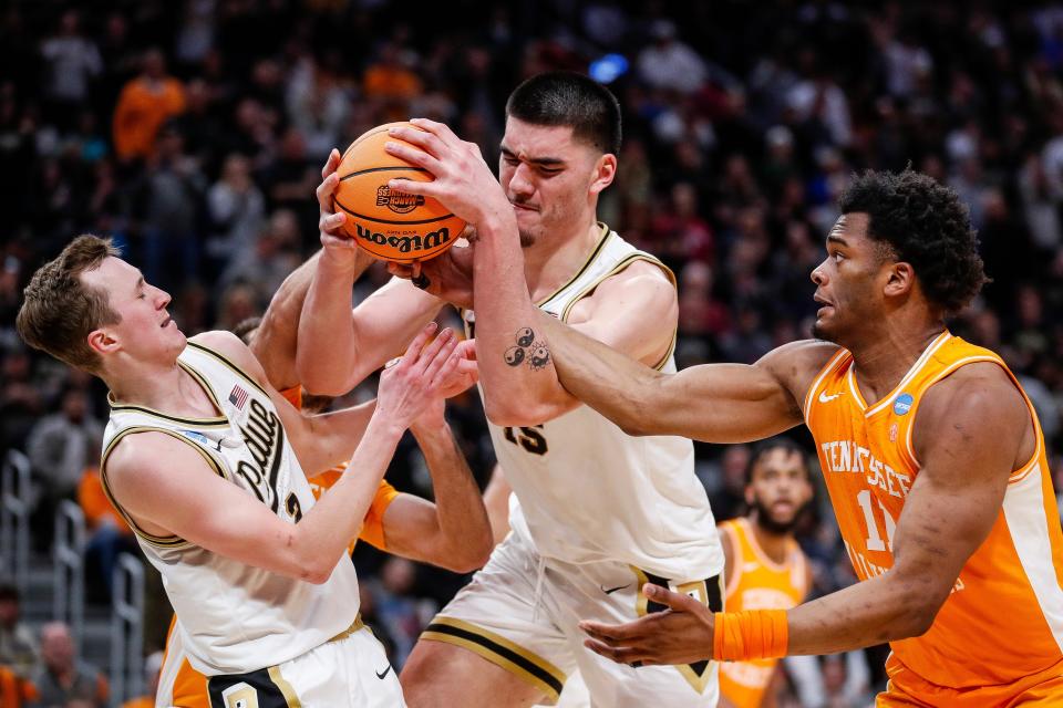 Purdue center Zach Edey (15) and guard Fletcher Loyer (2) battle for a rebound against Tennessee forward Tobe Awaka (11) during the Midwest Regional championship game of the 2024 NCAA men's tournament at Little Caesars Arena.