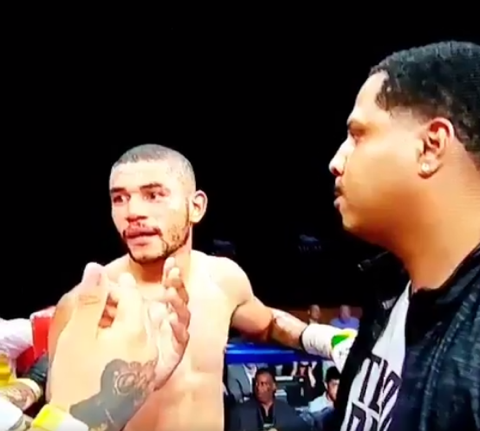 Jose Uzcategui (L) stands in his corner, seconds after being disqualified for hitting Andre Dirrell late and seconds before Dirrell’s trainer, Leon Lawson (R), punched him in the face unprovoked. (Screen grab from Showtime)
