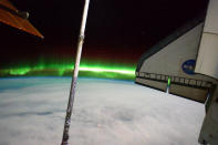 The Southern Lights or Aurora Australis and the port side wing of NASA space shuttle Atlantis (R) can be seen from the International Space Station July 14, 2011 in space. (NASA via Getty Images)