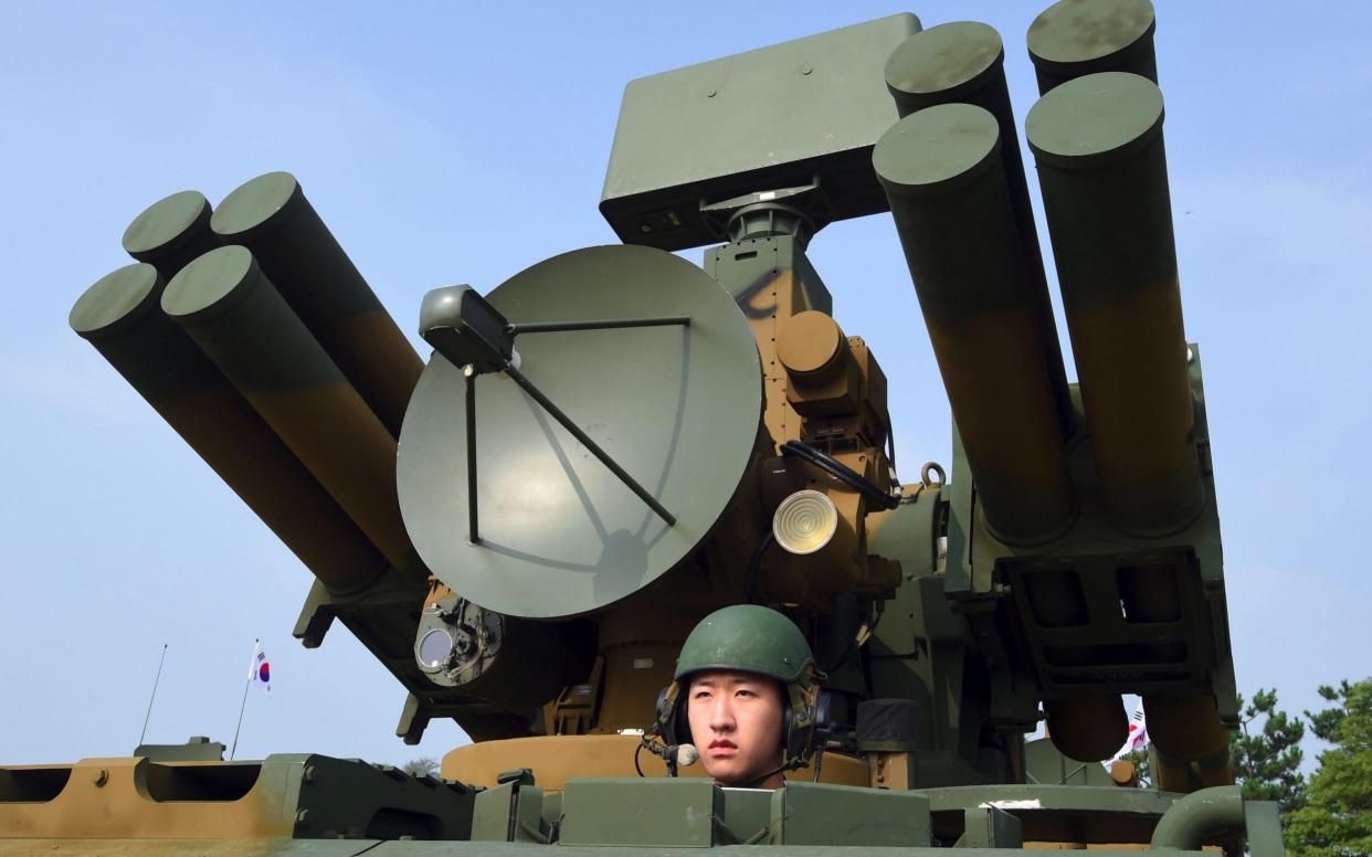 A South Korean soldier sitting on a Chunma self-propelled short range air defense missile system - AFP