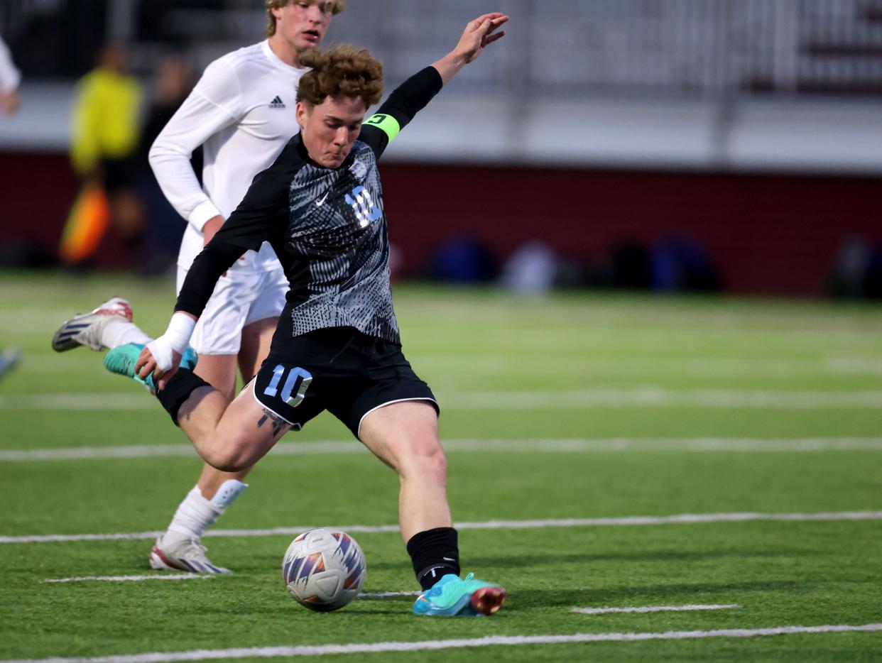 Edmond Memorial's Roman Hemphill shoots at goal during the boys high school soccer game between Edmond Memorial and Deer Creek at Edmond Memorial High School in Edmond, Oklahoma, Friday, April 19, 2024.