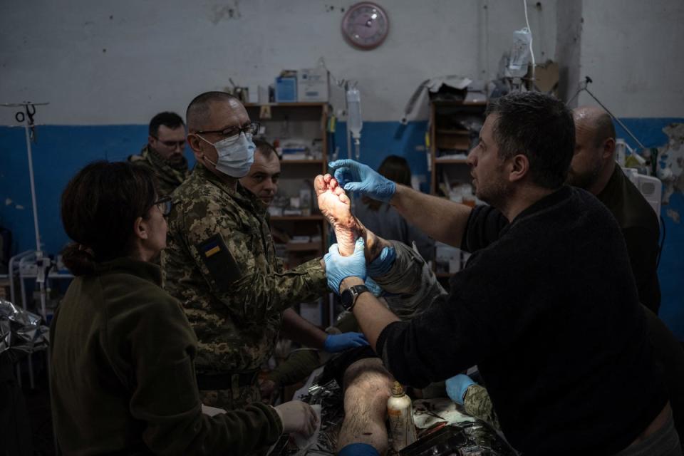 A soldier is treated in the operation room (Reuters)