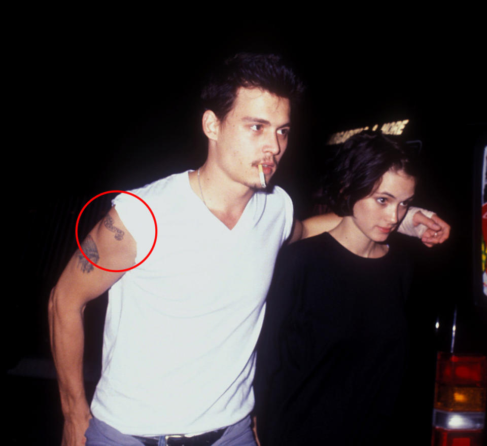 Johnny Depp flashes his tattoo for Winona Ryder. (Photo: Barry King/WireImage)