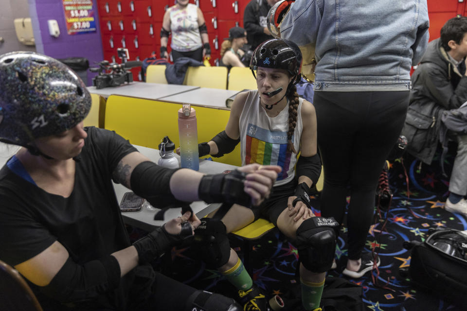 Members of the Long Island Roller Rebels, get prapared for a practice, Tuesday, March 19, 2023, at United Skates of America in Seaford, N.Y. (AP Photo/Jeenah Moon)