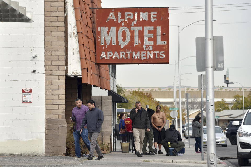 Investigators work the scene of a fire at a three-story apartment complex early Saturday, Dec. 21, 2019 in Las Vegas. The fire was in first-floor unit of the Alpine Motel Apartments and its cause was under investigation, the department said. Authorities say multiple fatalities were reported and many more were injured. (AP Photo/David Becker)