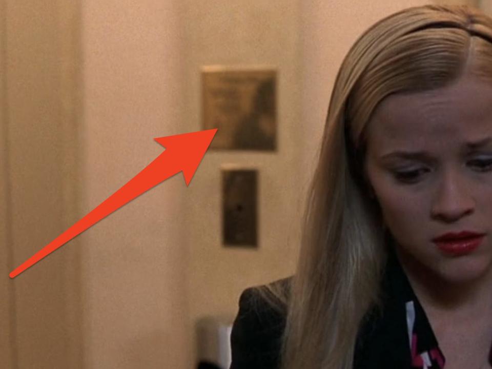 red arrow pointing to vivian's reflection behind elle in a scene from legally blonde