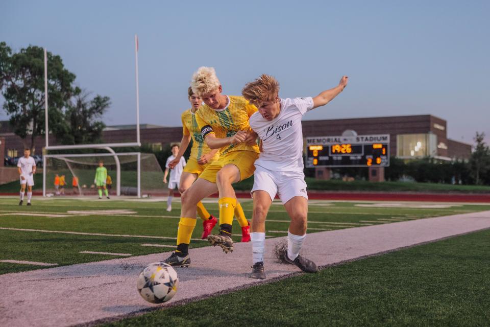 CMR's Alex Reeves, left, and Schaefer Graf of Great Falls High battle for the ball near the sideline in the boys' crosstown soccer game Thursday night at Memorial Stadium.