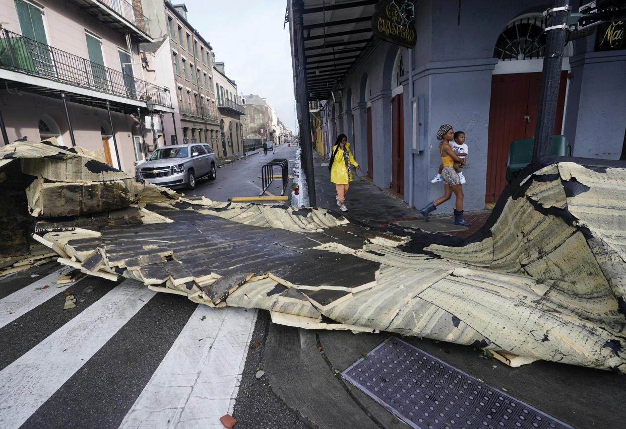 A roof blown off a building in the French Quarter by Hurricane Ida blocks an intersection Monday in New Orleans. 