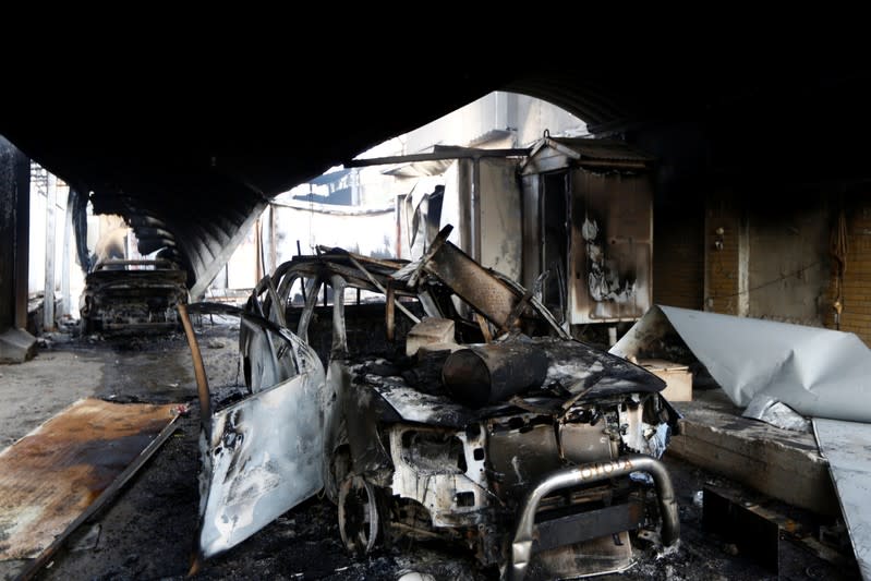 The wreckage of two cars that were burnt when Iraqi demonstrators stormed and set fire to the Iranian consulate during ongoing anti-government protests in Najaf