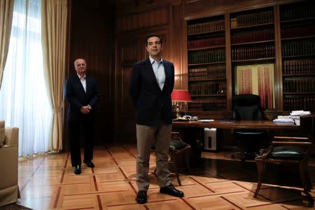 Greek Prime Minister Alexis Tsipras waits to welcome European Economic and Financial Affairs Commissioner Pierre Moscovici (not pictured) at his office in Maximos Mansion in Athens, Greece July 25, 2017. REUTERS/Alkis Konstantinidis