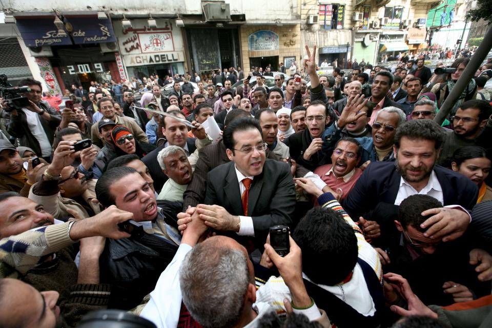 Ayman Nour (c) the Leader of the Ghad Opposition Party is mobbed by supporters outside his party's headquarters following his release from prison on February 19, 2009. (Mike Nelson/EPA/Shutterstock) 