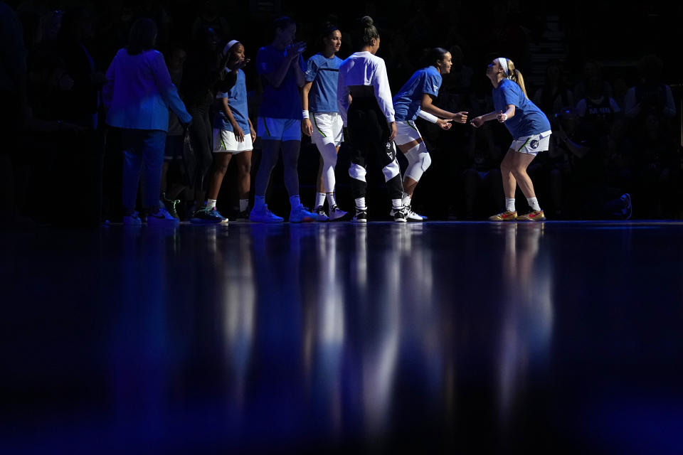 Minnesota Lynx forward Napheesa Collier, second right, is introduced before a WNBA basketball game against the Los Angeles Sparks, Sunday, June 11, 2023, in Minneapolis. (AP Photo/Abbie Parr)