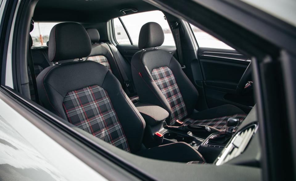 <p>The base GTI’s plaid upholstery is accented with Rabbit tags on the seats and red-stitched floor mats.</p>