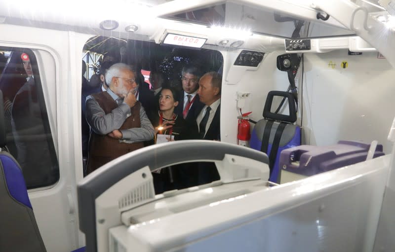 Russian President Putin and Indian Prime Minister Modi inspect a helicopter on the sidelines of the Eastern Economic Forum in Vladivostok