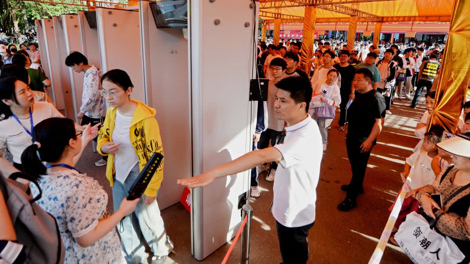 Students line up to pass a security check outside a school on the first day of "gaokao" in Bozhou, China, on June 7, 2024. - AFP/Getty Images