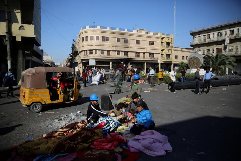 Demonstrators rest as they take part in the ongoing anti-government protests near Ahrar bridge in Baghdad