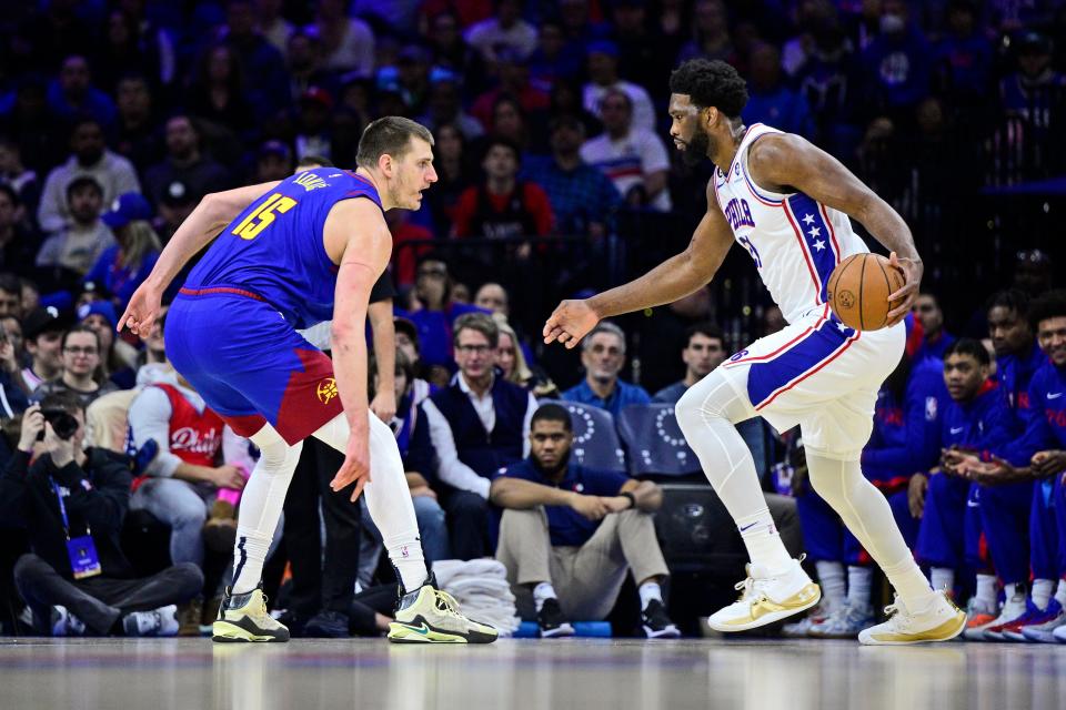 Philadelphia 76ers' Joel Embiid, right, looks to get around Denver Nuggets' Nikola Jokic during a game on Jan. 28. The two are the top candidates for NBA MVP.