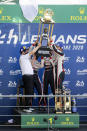 The Toyota TS050 Hybrid No8 of the Toyota Gazoo Racing Team's drivers Sebastien Buemi of Switzerland, Kazuki Nakajima of Japan and Brendon Hartley hold the trophy during the podium ceremony of the 88th 24-hour Le Mans endurance race, in Le Mans, western France, Sunday, Sept. 20, 2020. (AP Photo/David Vincent)