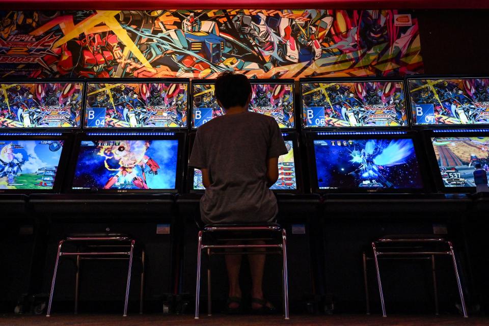 This photo taken on September 25, 2022 shows a man playing a video game at the GiGO Akihabara Building number 4, previously known as the Sega Akihabara Building number 4, which was filled with floors of arcade and video games, in the popular electronics shopping area of Akihabara in Tokyo. - With the arcade industry struggling with fewer visitors due to Covid-19 and a trend to online gaming, the arcade - located directly opposite the train station - closed its doors on September 25 after the lease expired. (Photo by Richard A. Brooks / AFP) (Photo by RICHARD A. BROOKS/AFP via Getty Images)