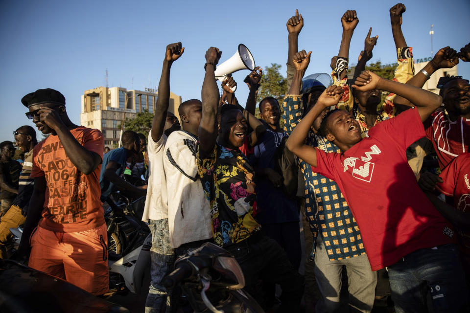 A crowd gathered Place de la Nation celebrate at the announcement that Lt. Col. Paul Henri Sandaogo Damiba has taken the reins of the country in Ouagadougou Monday Jan. 24, 2022. More than a dozen mutinous soldiers declared Monday on state television that a military junta now controls Burkina Faso after they detained the democratically elected president following a day of gun battles in the capital. (AP Photo/Sophie Garcia)