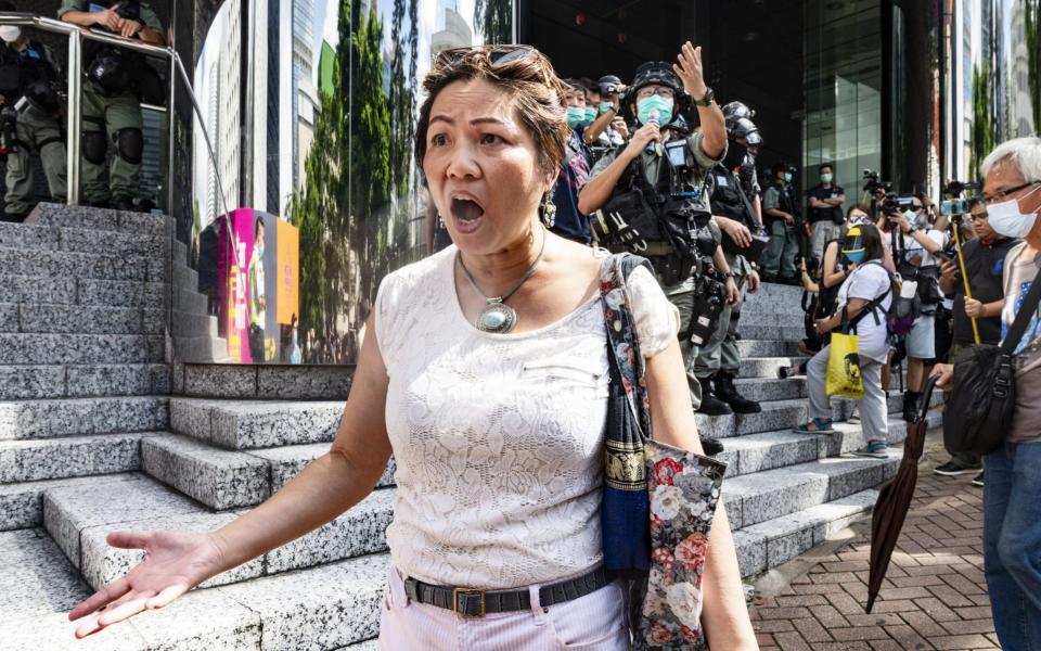 A woman argues with police officers during a march to celebrate US Independence Day outside the US consulate in Hong Kong  - Anadolu Agency/Anadolu