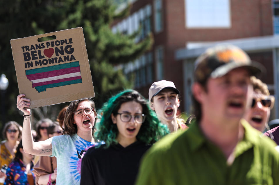 Transgender rights activists hold signs as they march through the University of Montana campus on May 3, 2023 in Missoula, Mont. (Justin Sullivan / Getty Images file)