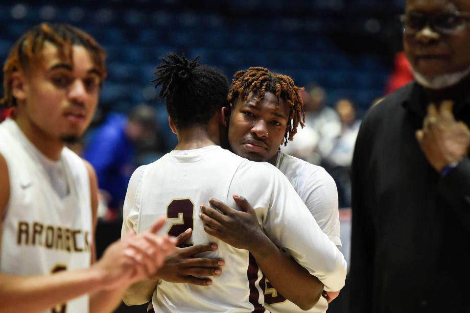 Cross Creek Ahmad Hunt (23) hugs teammate Jayden Pack (2) after the Cross Creek and Windsor Forest Class AAA state championship game at the Macon Coliseum in Macon on Friday, March 11, 2022. Cross Creek defeated Windsor Forest 60-53.