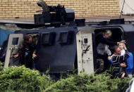 People are evacuated with an armoured vehicle near a police checkpoint in Kumanovo, Macedonia May 9, 2015. REUTERS/Ognen Teofilovski