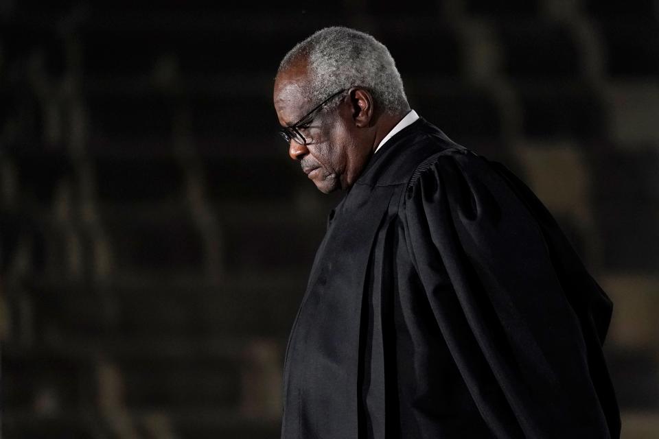 Supreme Court Justice Clarence Thomas listens as President Donald Trump speaks before administering the Constitutional Oath to Amy Coney Barrett on the South Lawn of the White House in Washington on Oct. 26, 2020.