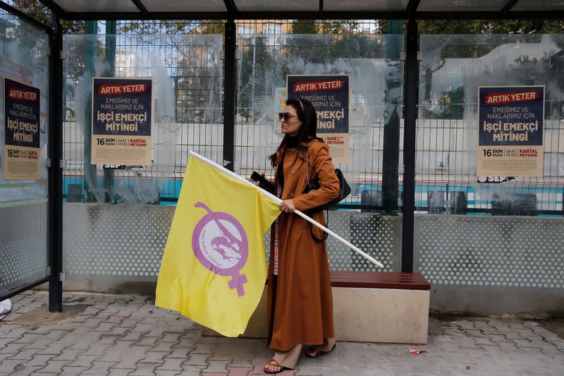 Mikaeil Alizadeh, also known by her stage name Leo, holds a flag before attending a labour rally in Istanbul