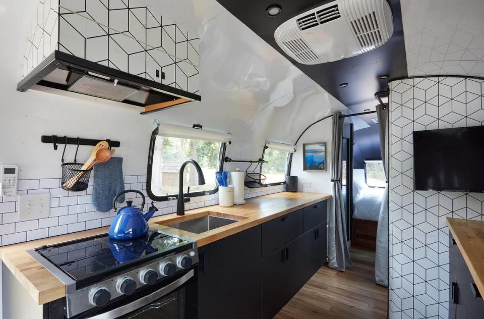 Airstreams at Asheville River Cabins include a kitchen, bathroom, private deck and firepit.
