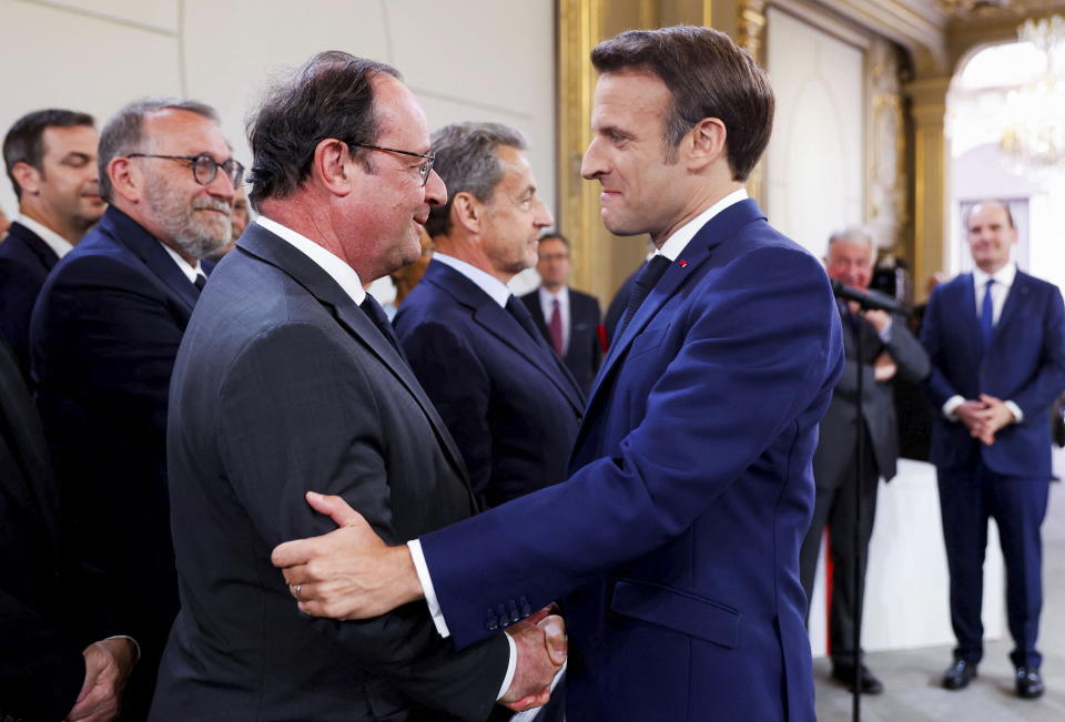 France's former President Francois Hollande, left, greets French President Emmanuel Macron during the ceremony of his inauguration for a second term at the Elysee palace, in Paris, France, Saturday, May 7, 2022. Macron was reelected for five years on April 24 in an election runoff that saw him won over far-right rival Marine Le Pen. (Gonzalo Fuentes/Pool via AP)