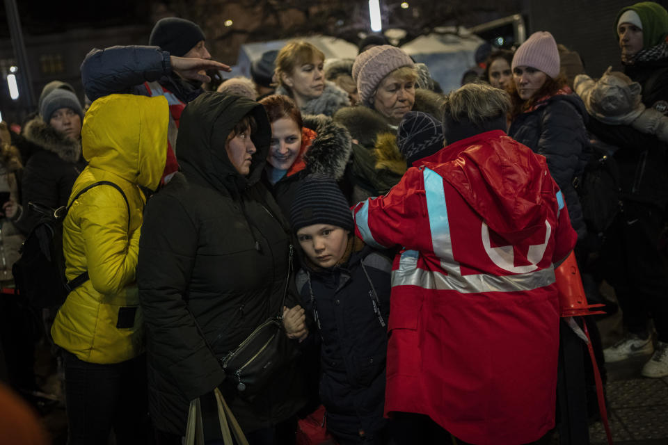 Displaced Ukrainians queue to board a bus to Poland outside Lviv train station in western Ukraine on Saturday, March 5, 2022. Russian troops took control of the southern port city of Kherson this week. Although they have encircled Kharkiv, Mykolaiv, Chernihiv and Sumy, Ukrainian forces have managed to keep control of key cities in central and southeastern Ukraine, Ukrainian President Volodymyr Zelenskyy said Saturday. (AP Photo/Bernat Armangue)