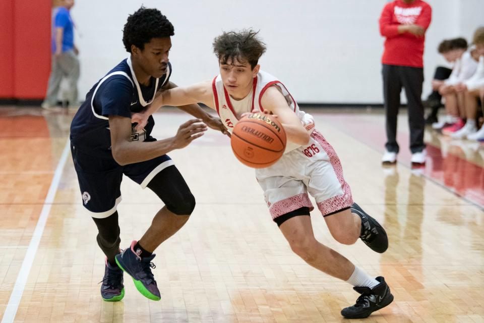 Pueblo Centennial's Jeffrey Valdez dribbles past a Lincoln defender during a game on Jan. 13, 2023.