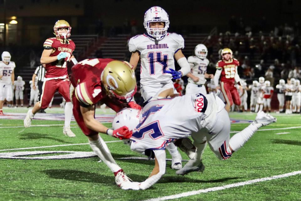 Portsmouth's Stone Karnacewicz (4) brings down Memorial's Jathyen Torress in Friday's Division I football game.