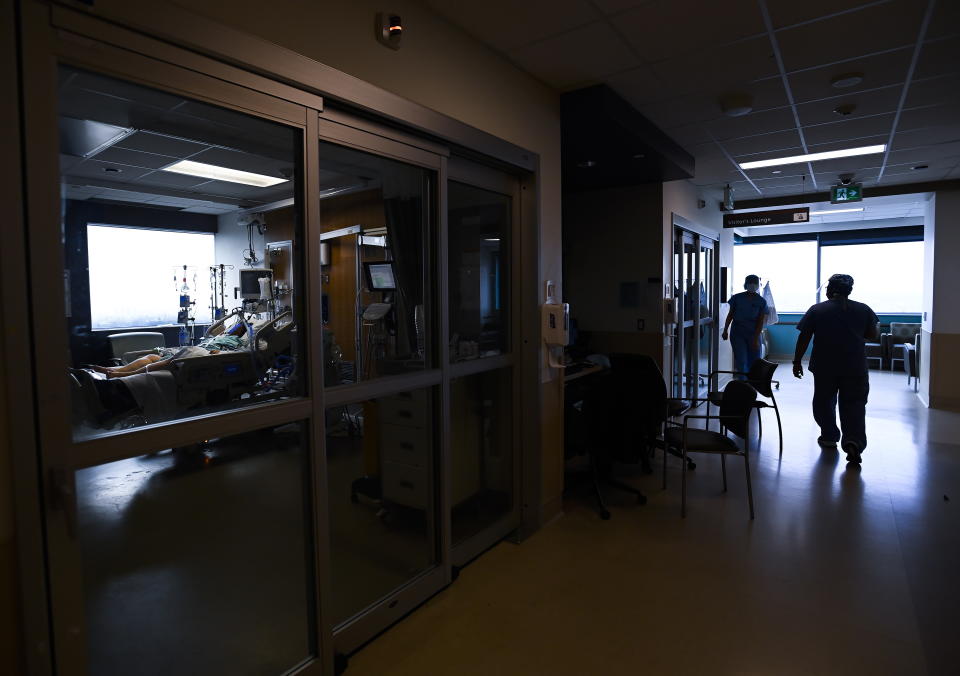 A 47-year-old woman, left, who is intubated and on a ventilator is one of many in the intensive care unit at the Humber River Hospital during the COVID-19 pandemic in Toronto on Tuesday, April 13, 2021. (Nathan Denette/The Canadian Press via AP)