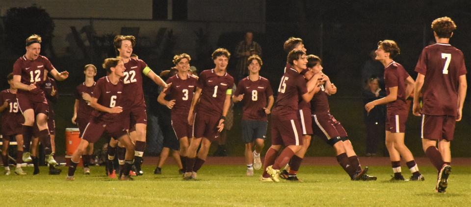 The Frankfort-Schuyler Maroon Knights celebrate Roman Harrod's winning goal in overtime against Poland Monday.